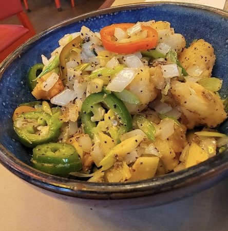 Salt and pepper shrimp with jalapenos and onions, marked gluten-free on Qi Austin's menu